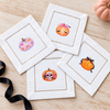 Girlie Halloween Pumpkins Set 1 — mini pumpkin transfers on white hemstitched cocktail napkins