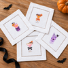 Halloween Cocktails 3 - four mini DTF transfer designs shown on white hemstitched cocktail napkins