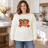 Woman wearing an ivory long-sleeve tee with Fall Leave Mason Jars autumn floral transfer