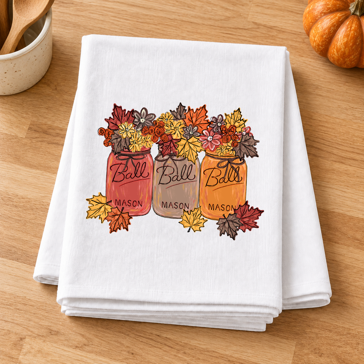 Fall Leave Mason Jars transfer with autumn flowers and leaves on a folded white kitchen towel