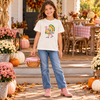 Girl wearing an ivory tee with colorful Preppy Turkey in pink boots